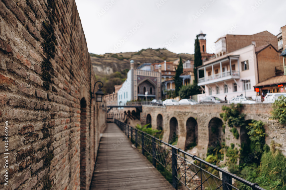 01.06.2019 Tbilisi, Georgia: view of old stone houses with beautiful colored roofs in the center of the old town where tourists are walking