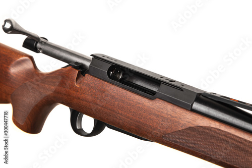 Modern bolt carbine isolated on white background. Close-up of a weapon with a wooden butt for hunting, sports and self-defense.