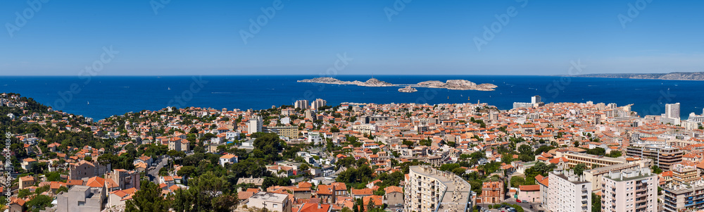 Panoramic summer view on Marseille rooftops with Ile du Frioul and Ile d'If and the Mediterranean Sea. Bouches-du-Rhône (13), Provence-Alpes-Cote d'Azur, France, Europe