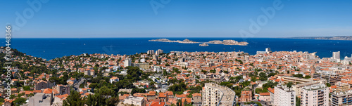 Panoramic summer view on Marseille rooftops with Ile du Frioul and Ile d'If and the Mediterranean Sea. Bouches-du-Rhône (13), Provence-Alpes-Cote d'Azur, France, Europe