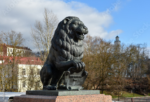 Autumn landscape. Sculpture of a lion on the background of the city of Vitebsk. Selective focus