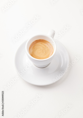 Cup of coffee isolated on white paper background. Close up. 