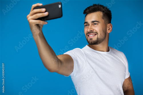 Handsome american man takes a selfie and smiles at the camera photo