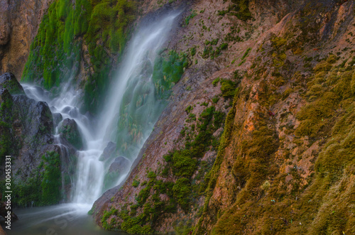 Close detail of Pisoaia waterfall streaming down through the moss in Apuseni Mountains  Transylvania  Romania