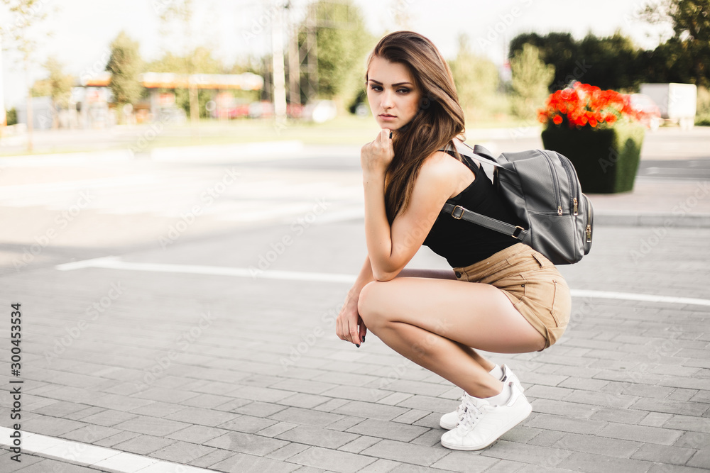Beautiful young model posing for the camera on the street.