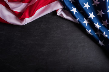 Happy Veterans Day. American flags veterans against a blackboard background.