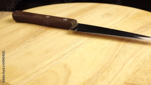 metal knife with brown wooden handle rotates 360 degrees.
