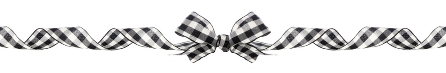 Long Christmas border of black and white buffalo plaid bow and ribbon isolated on a white background