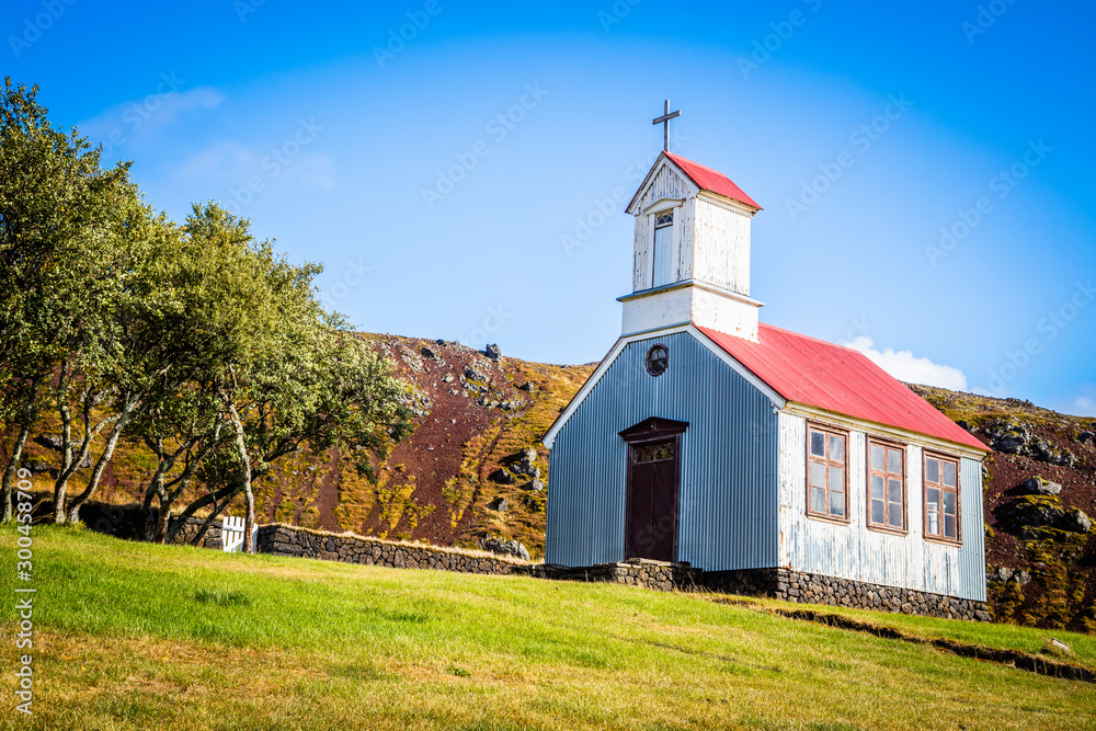 Traditional quaint Icelandic corrugated iron church with red roof