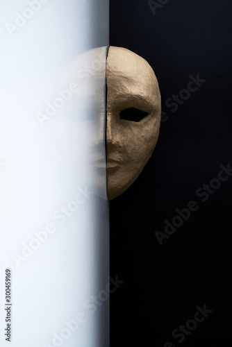 Composition with half of the paper masks on a light gray background with a delicate bouquet of flowers