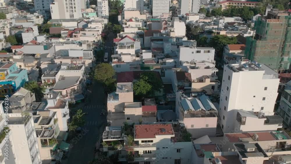 a flying camera flies over the roofs of Vietnamese slums and houses, overlooking the road and predizayuschie cars, different angles, view from top to bottom. a flying camera flies over the roofs of Vietnamese slums and houses, overlooking the road and predizayuschie cars, different angles, view from top to bottom.