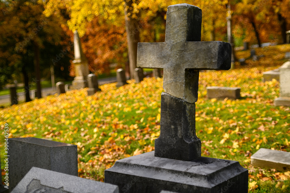 cross in cemetery in Autumn cross in cemetery in Autumn