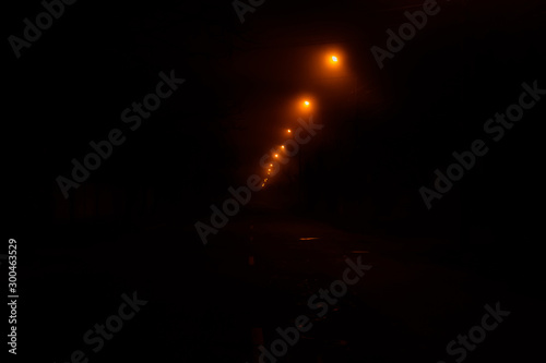 Old street at night illuminated by the lanterns