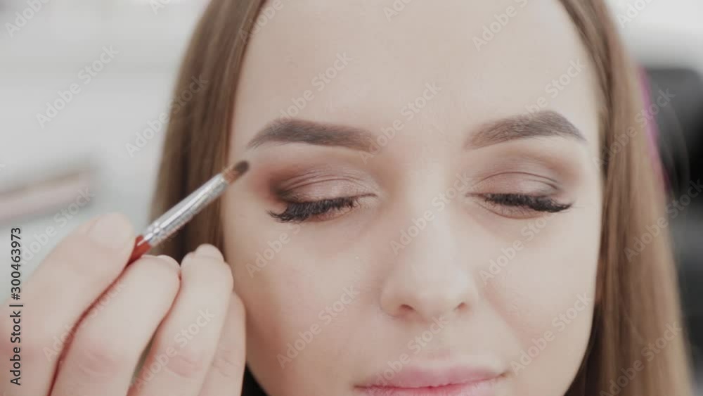 Professional makeup artist woman stirs makeup cream on a palette. Professional makeup artist woman stirs makeup cream on a palette.