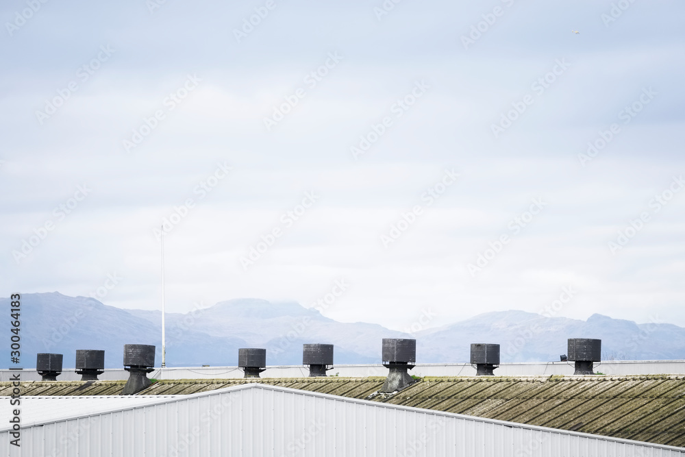 Industrial factory chimney exhaust terminal pots against landscape mountain background
