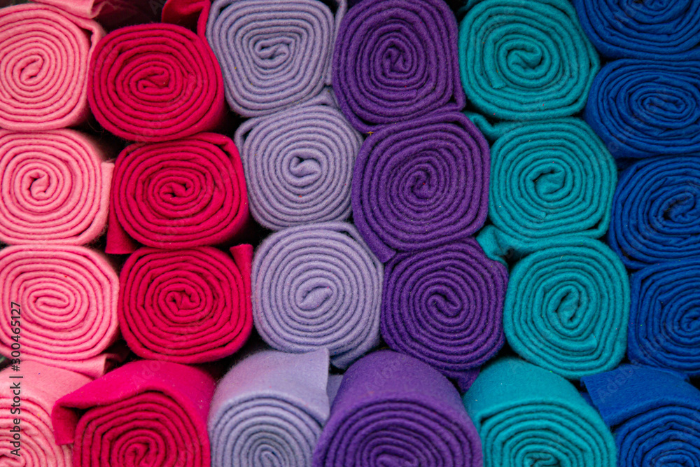 abstract background of rolled blankets in different colors