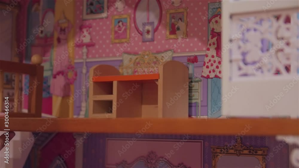 Little girl playing toy house surprise present gift doll house daughter female caucasian white european closeup Little girl playing toy house surprise present gift doll house daughter female caucasian white european closeup