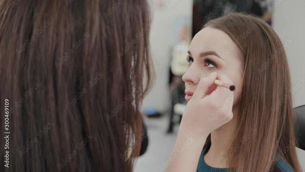 Professional makeup artist woman stirs makeup cream on a palette. Professional makeup artist woman stirs makeup cream on a palette.