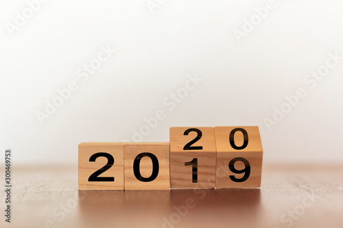 New year concept. Wooden cubes flip from old year to new year