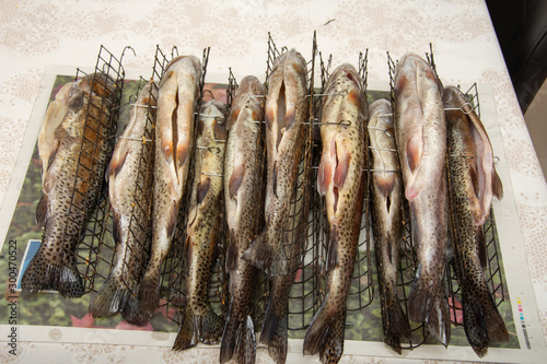 Fresh smoked fish in a smokehouse: carps, smoked trout