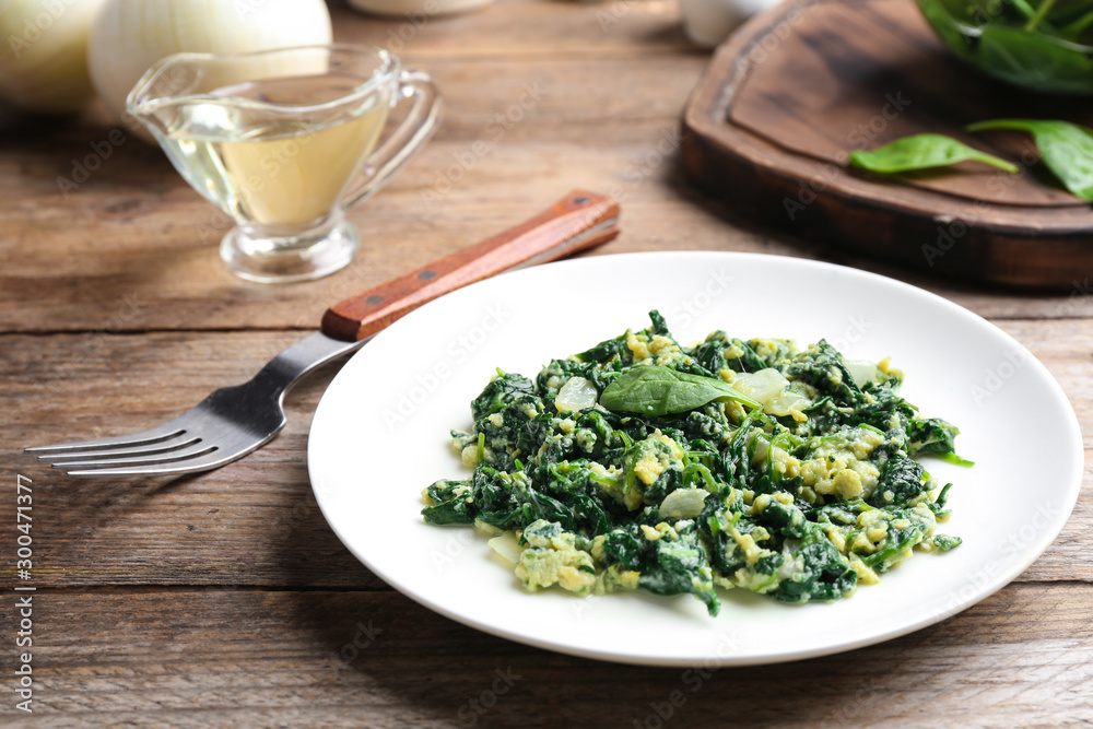 Tasty cooked spinach served on wooden table. Healthy food Tasty cooked spinach served on wooden table. Healthy food