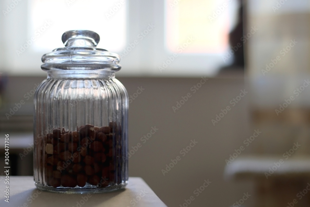 Hazelnuts in a jar on a table. Selective focus. Hazelnuts in a jar on a table. Selective focus.