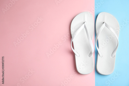 Flat lay composition with flip flops on color background, space for text. Beach objects