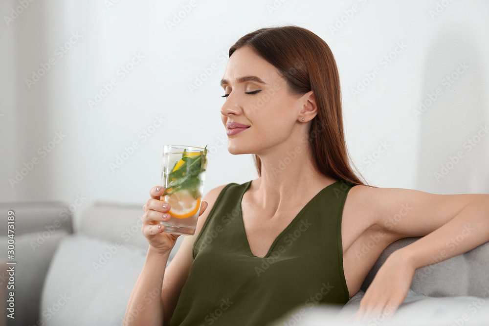 Young woman with lemonade at home. Refreshing drink Young woman with lemonade at home. Refreshing drink