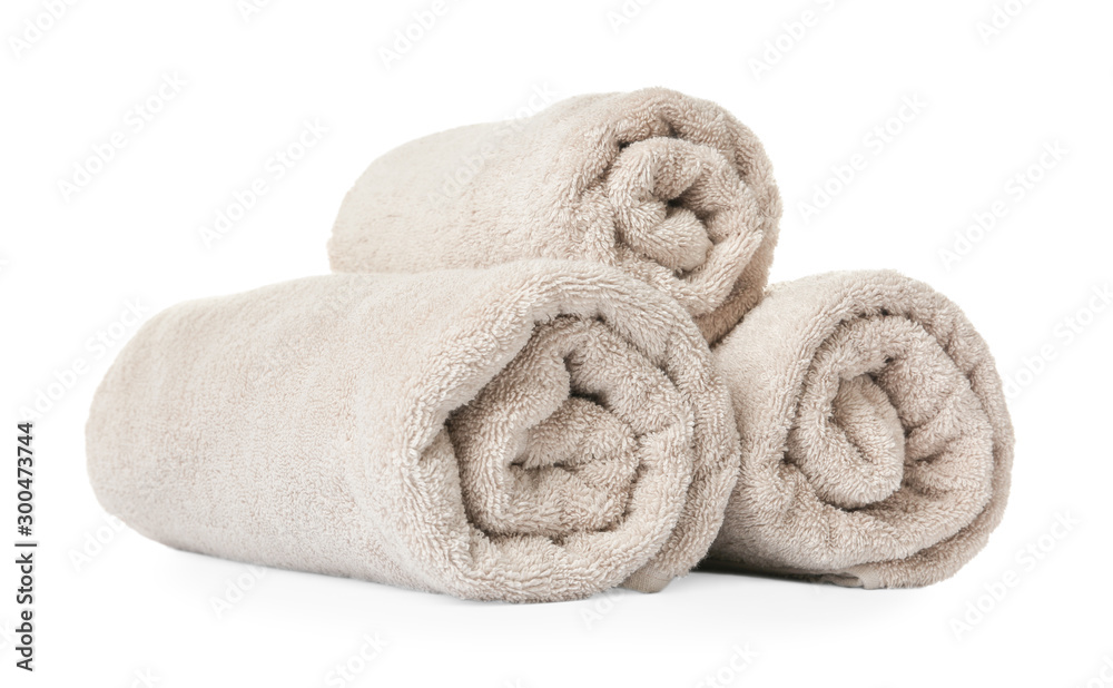Rolled clean beige towels on white background Rolled clean beige towels on white background