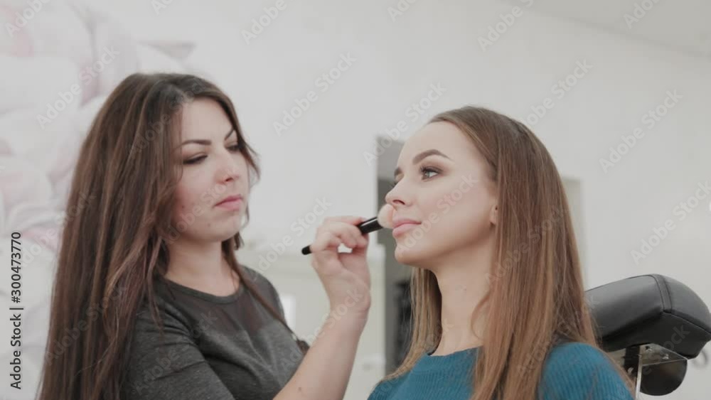Professional makeup artist woman stirs makeup cream on a palette. Professional makeup artist woman stirs makeup cream on a palette.