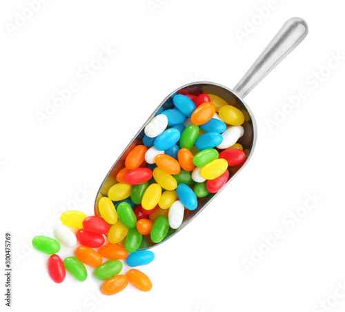 Cuadro en lienzo Scoop of tasty jelly beans on white background, top view