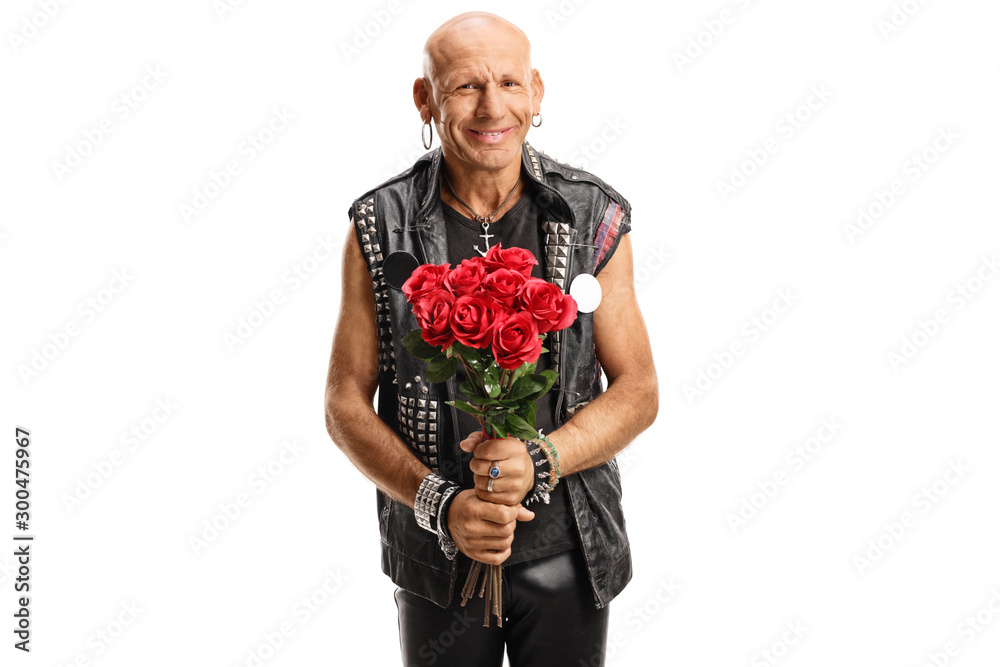 Cheerful punker holding red roses and smiling Cheerful punker holding red roses and smiling