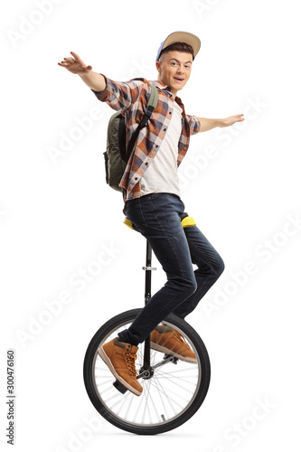 Excited male student riding a unicycle photo