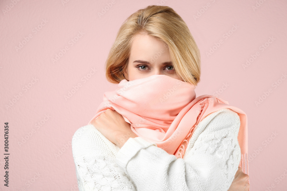 Beautiful woman wearing warm scarf on pink background. Autumn clothes Beautiful woman wearing warm scarf on pink background. Autumn clothes