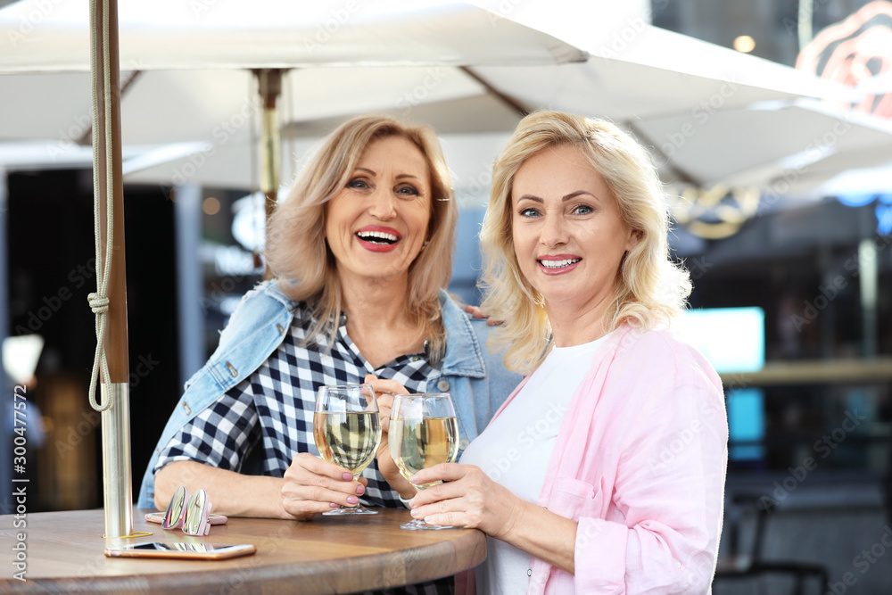 Mature women with drinks at outdoor cafe Mature women with drinks at outdoor cafe