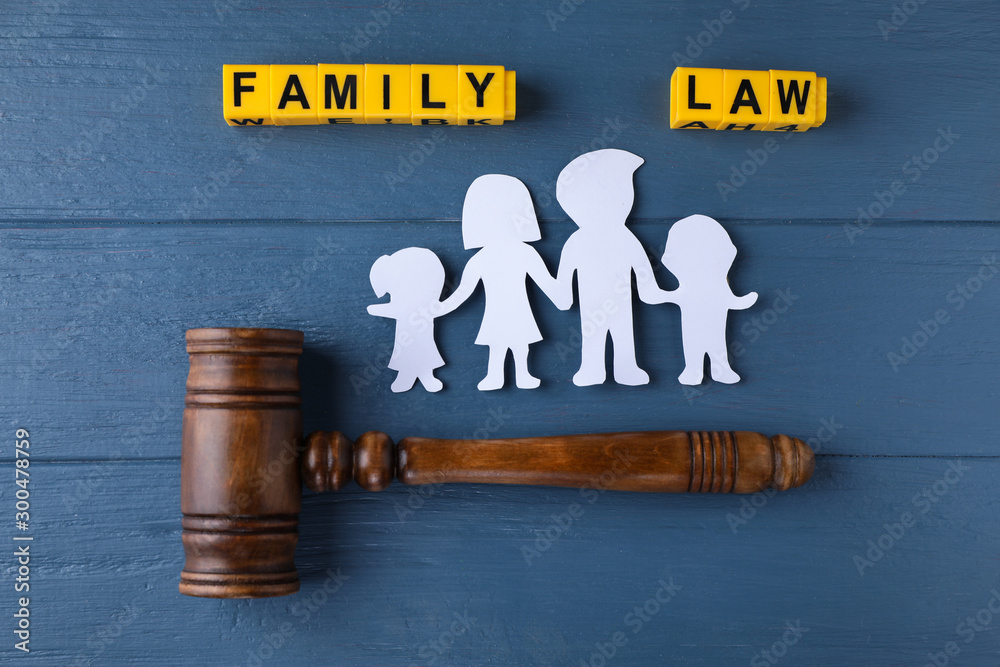 Flat lay composition with figure and gavel on blue wooden background. Family law concept - obrazy, fototapety, plakaty 