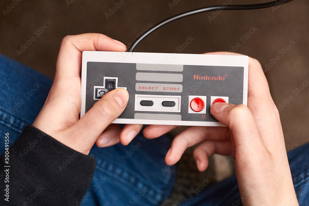 BUDAPEST, HUNGARY - FEBRUARY 17, 2018: Playing the classic Nintendo NES  console from the 80s, controller closeup Stock-Foto | Adobe Stock