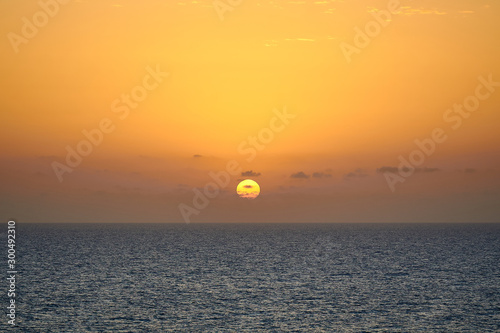sun rising at a sunrise above the sea