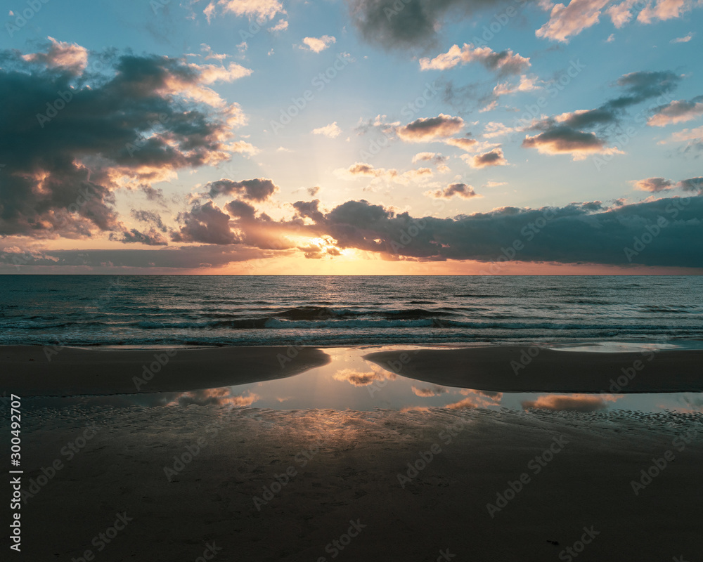 sunrise reflections on beach
