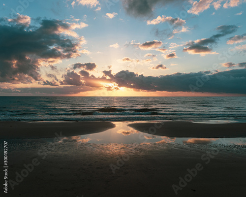 sunrise reflections on beach © Lauren