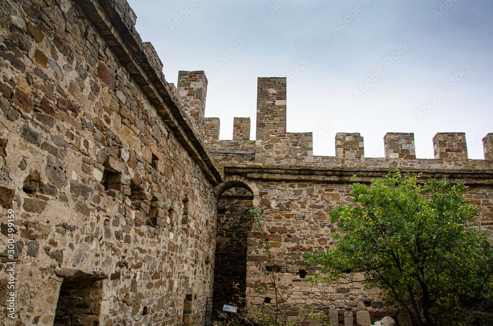 The wall of the old fortress, towers and structures, the ruins of the old fortress.