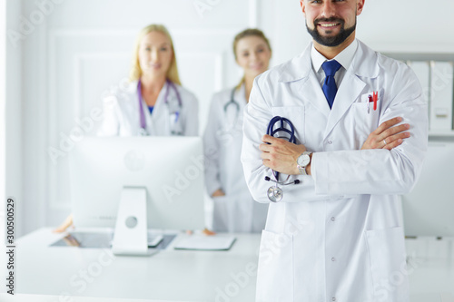 Young male doctor in front of medical group