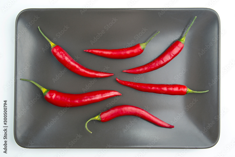 Red hot pepper close up on a grey plate Healthy vegetable food and vitamins.