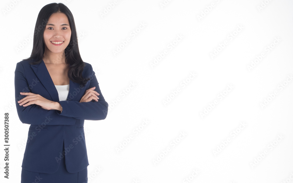 A businesswoman stands against a white wall in her company office with a smile, determined to lead the business team to A businesswoman stands against a white wall in her company office with a smile, determined to lead the business team to