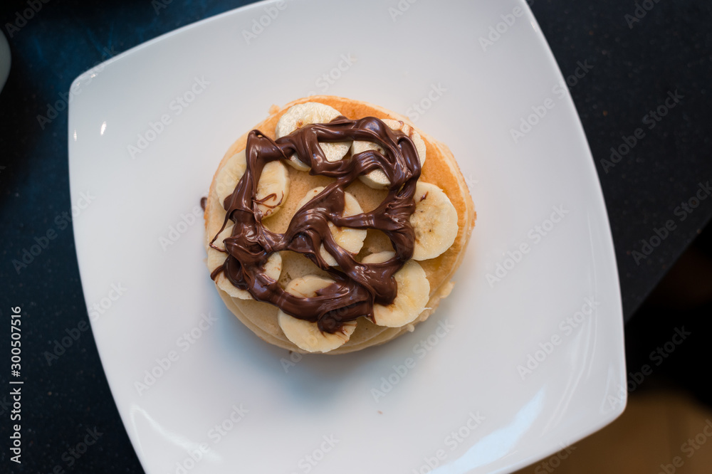 pancakes with chocolate sauce in white dish pancakes with chocolate sauce in white dish