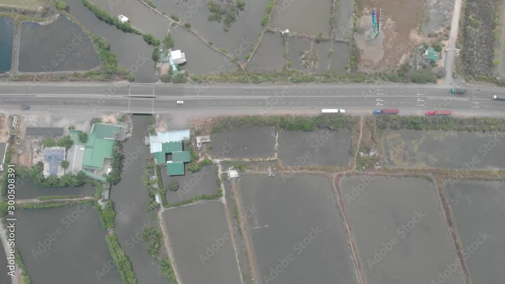 a flying camera flies over selected fields and an agricultural sector in Vietnam with a view of the mountains, the road and the jungle a flying camera flies over selected fields and an agricultural sector in Vietnam with a view of the mountains, the road and the jungle