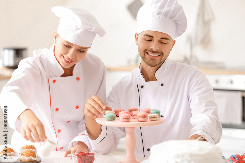 Young confectioners cooking tasty dessert in kitchen Young confectioners cooking tasty dessert in kitchen
