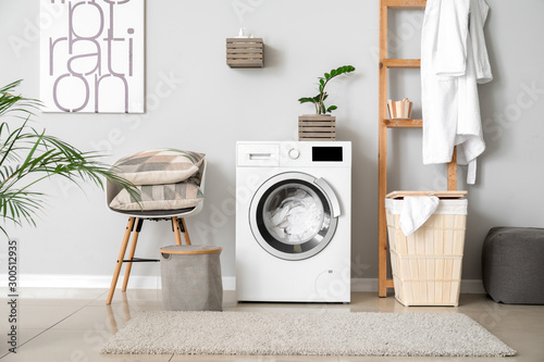 Fotografia Interior of home laundry room with modern washing machine