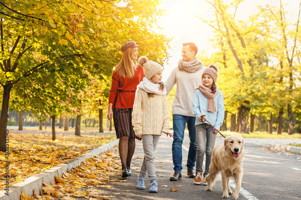 Happy family with dog walking in autumn park Happy family with dog walking in autumn park