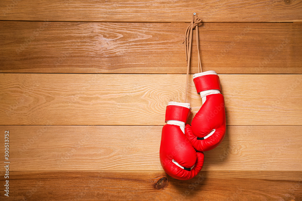 Pair of boxing gloves hanging on wooden wall